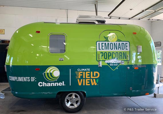 Channel Seed two-tone green wrapped Airstream marketing trailer